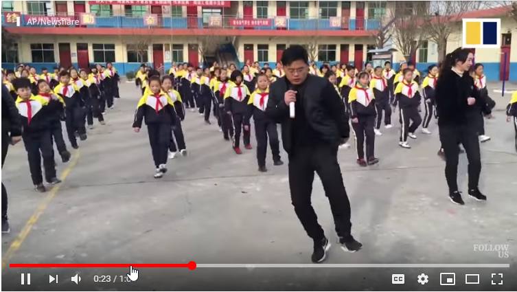 Video of a head teacher in China helping his students exercise using dance in the playground